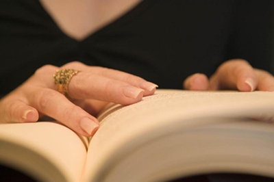 woman's hands on law book